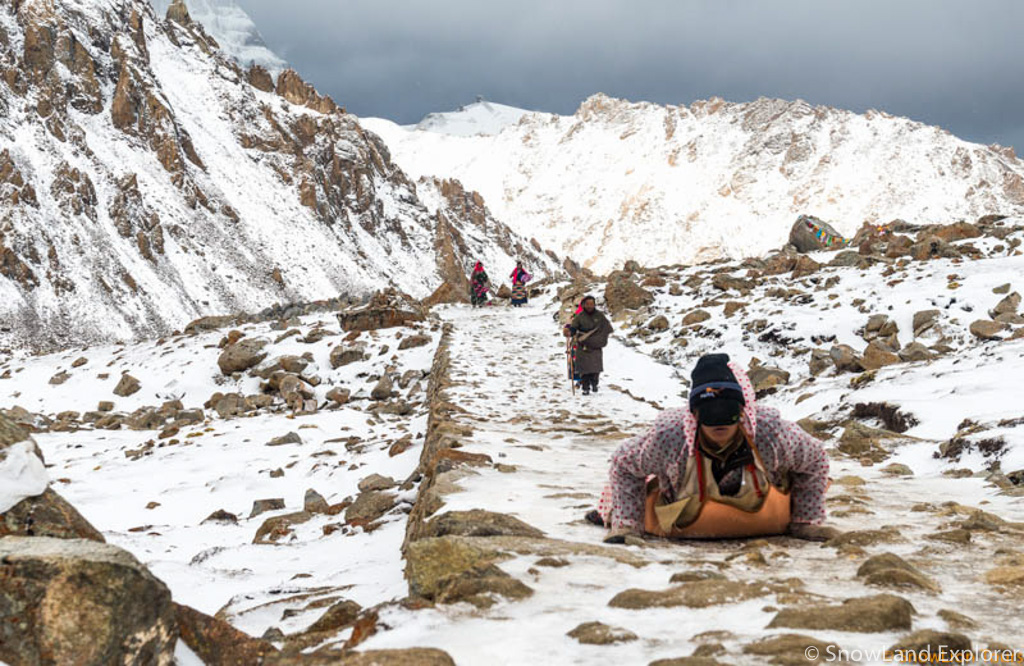 Tibetan pilgrims are making prostration around Mount Kailash